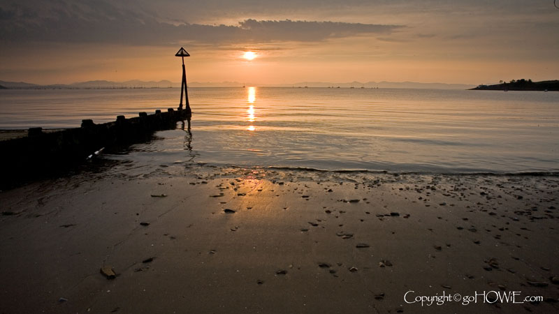 Abersoch beach at sunrise with groynes, Llyn Peninsula, Wales