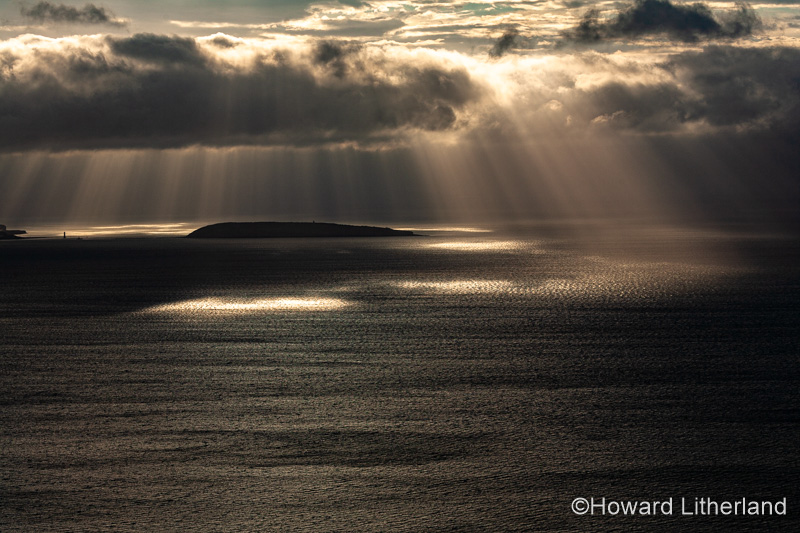 Puffin Island, Anglesey, North Wales with clouds and sunbeams