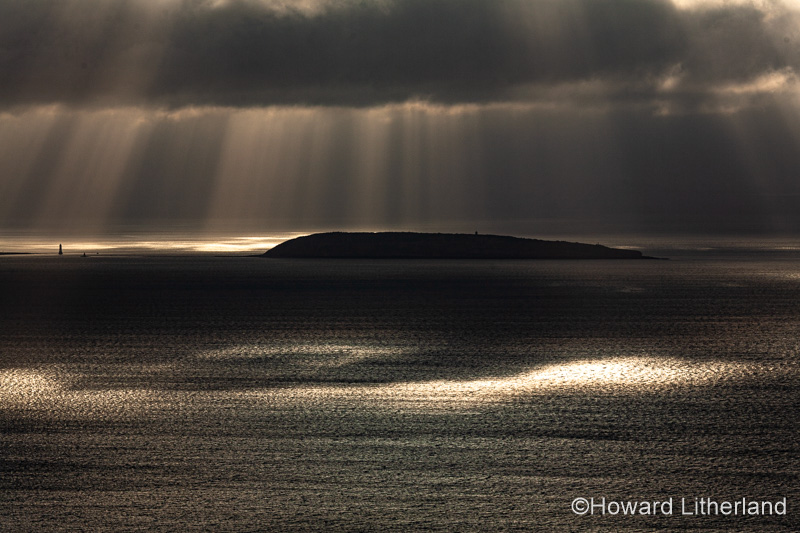 Puffin Island, Anglesey, North Wales with clouds and sunbeams