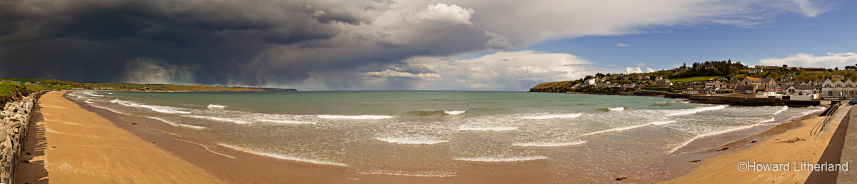 Panoramic image of the beach and approaching storm at Ardmore on the southwest coast of County Waterford, Ireland