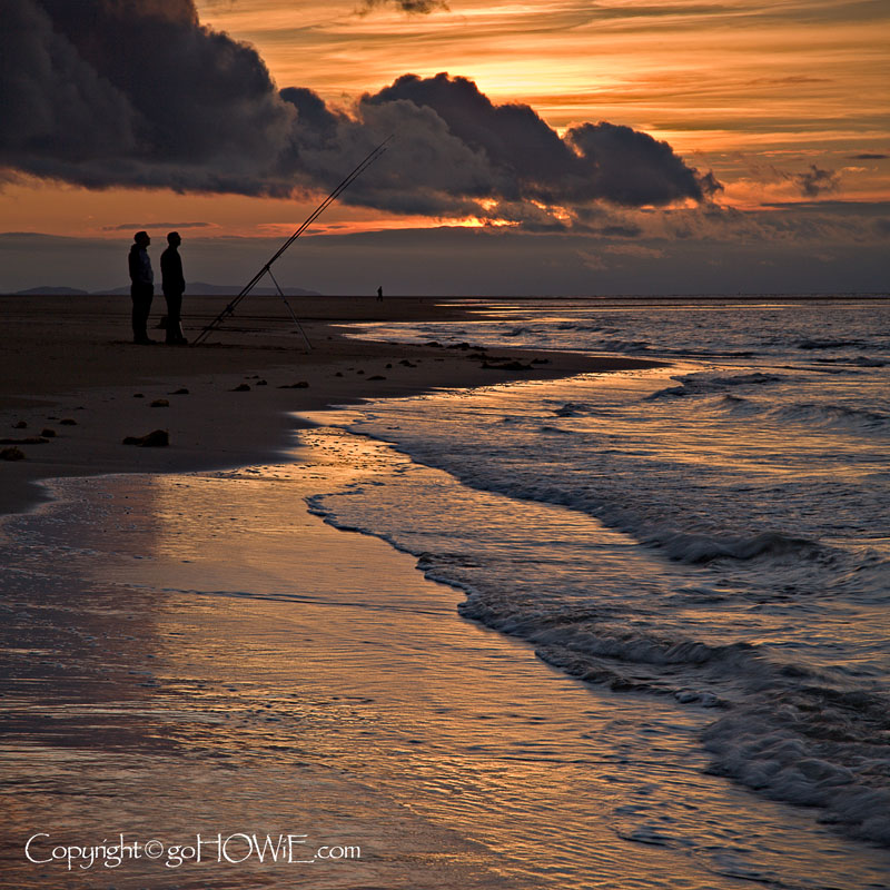 Anglers on the beach at sunset, Talacre, North Wales