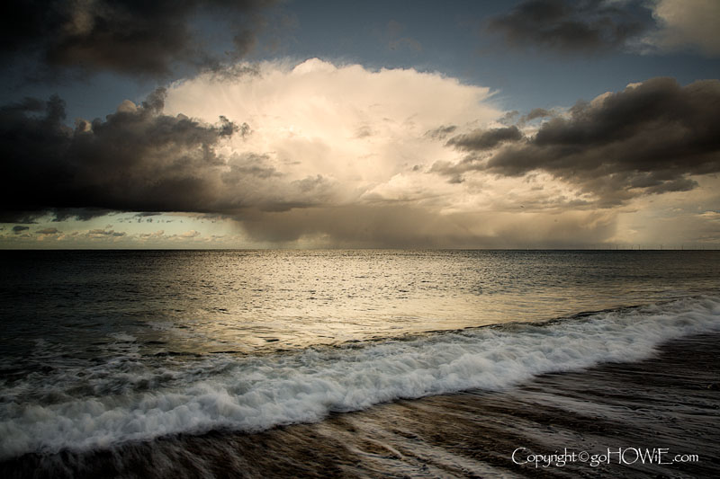 Llandudno East Shore beach with storm clouds and receding wave, North Wales coast