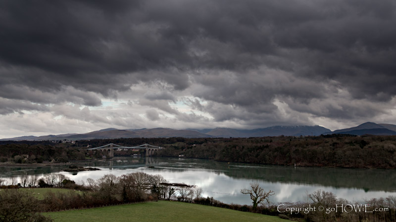 Thomas Telford's iconic suspension bridge over the Menai Straits, North Wales, under stormy clouds