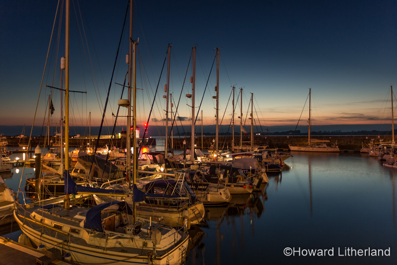 Yachts moored in the Victoria Dock at Caernarfon at dusk on the North Wales coast