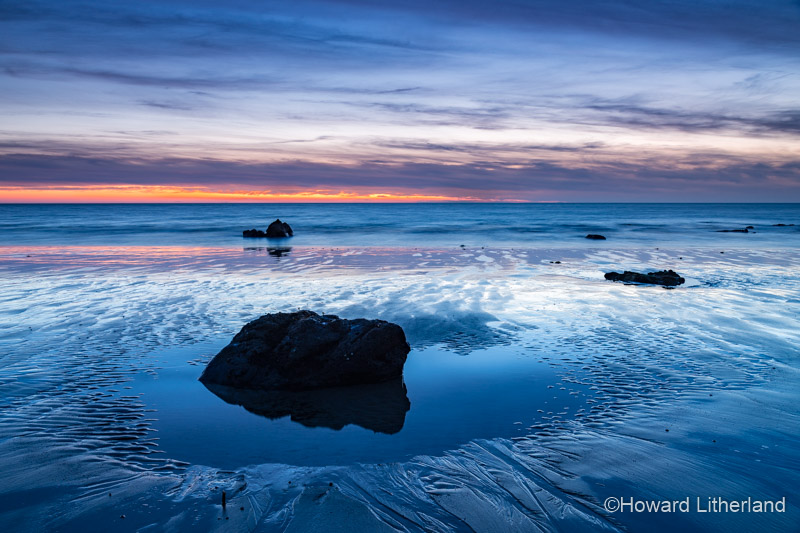 Rock on the beach at dusk at Church Bay, Anglesey, North Wales