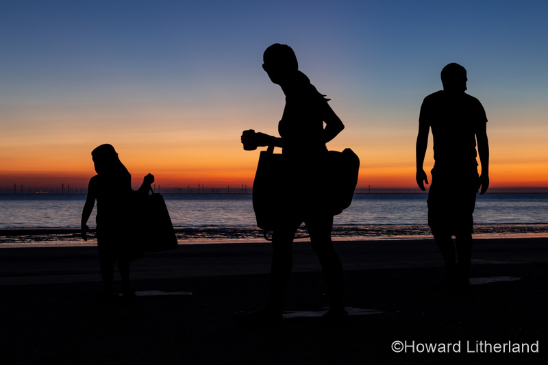 Sculptures of families on the seafront at Colwyn Bay at dawn, North Wales