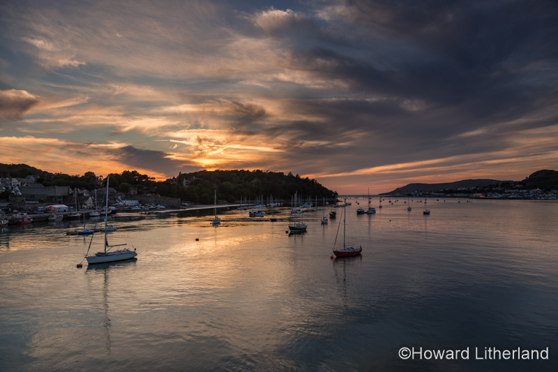 Boats moored in the Conwy estuary on the North Wales coast at sunset