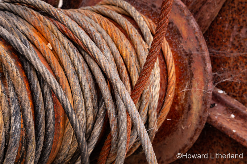 Old rusty cable drum and steel cable at Charlestown, Cornwall