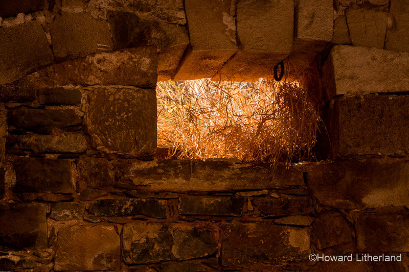 Stone wall and plain, brightly lit window, Spinalonga, Crete