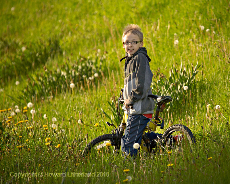 Boy on bike in field