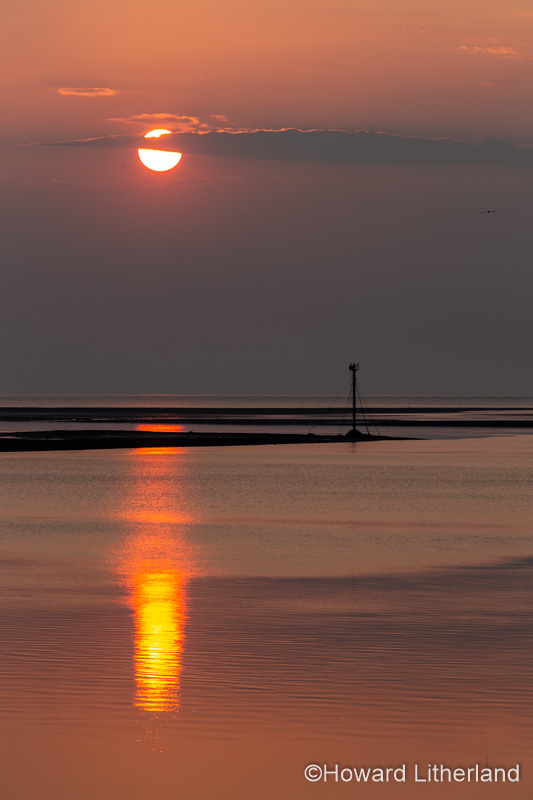 The setting sun over the Conwy estuary, viewed from Deganwy on the North Wales coast