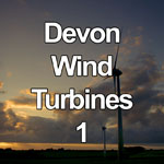 This video shows a pair of wind turbines rotating in a field in Devon, England at sunset