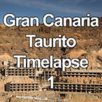 Time lapse video showing the arrival of the dawn and sunrise over the tourist resort of Taurito on the Atlantic coast of Gran Canaria in the Canary Islands, Spain, with the sunlight moving down a hillside and lighting up the shell of an unfinished resort hotel