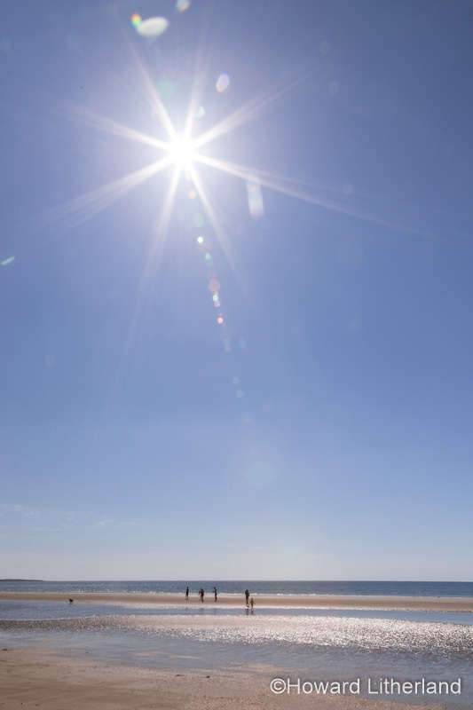 Sunstar over Harlech beach, Gwynedd, Wales