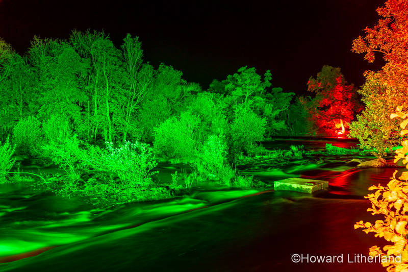 Night time illuminations of trees and river at Horseshoe Falls, River Dee, Llangollen, North Wales