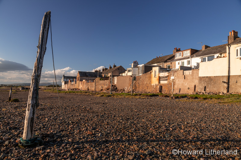 Old mooring post and houses at Ravenglass, Lake District, England