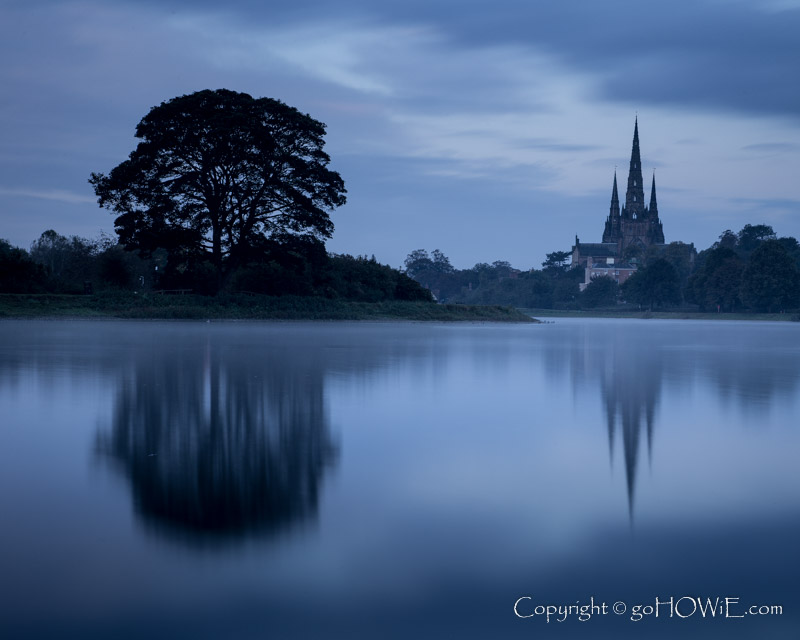 Lichfield cathedral at dawn, viewed though mist over Stowe Pool, Staffordshire