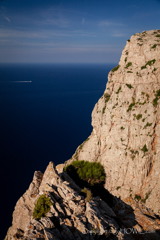 Cliff face at the Cuina del Moro viewpoint on the Cap de Formentor, Mallorca, with a boat out at sea to give a sense of scale