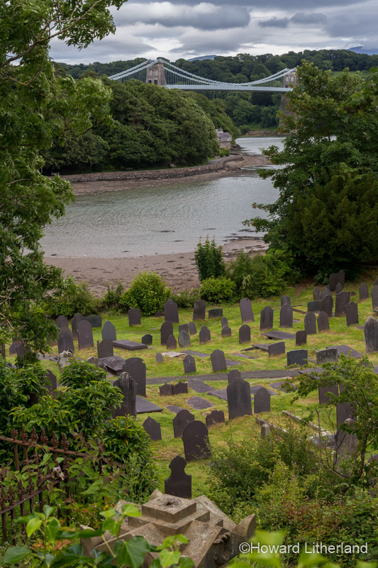 Church graveyard and suspension bridge on the Menai Straits, Anglesey, North Wales