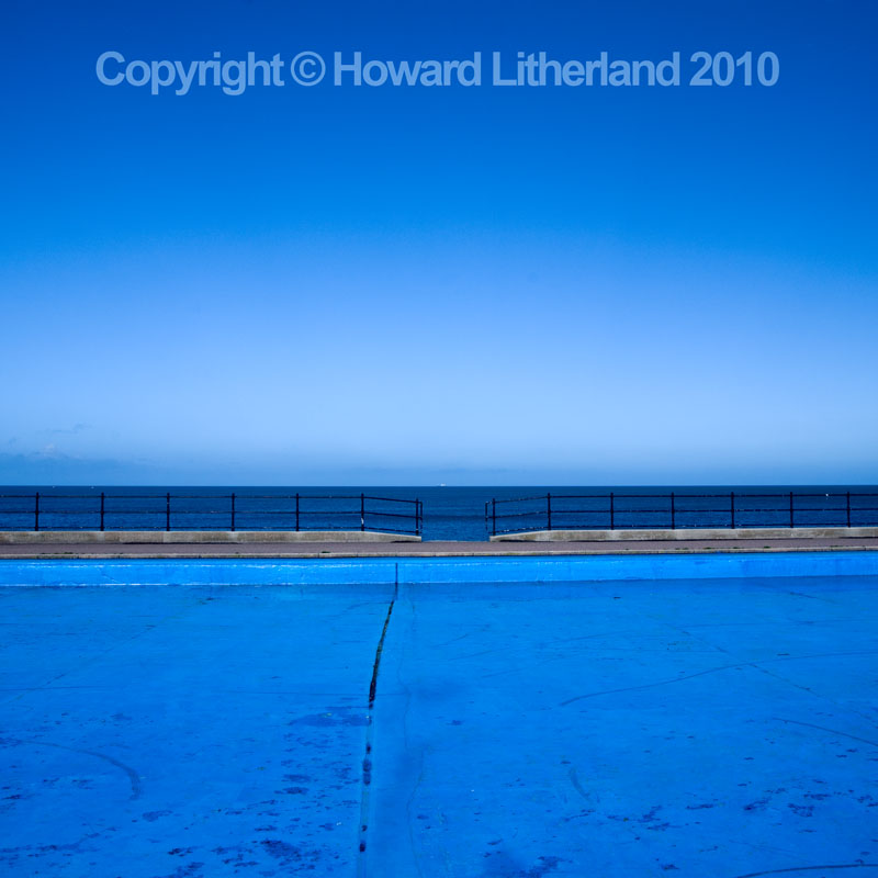 Empty blue paddling pool