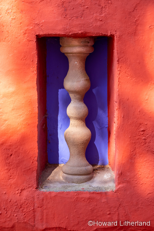 Carved stone pillar in a wall at Portmeirion, North Wales