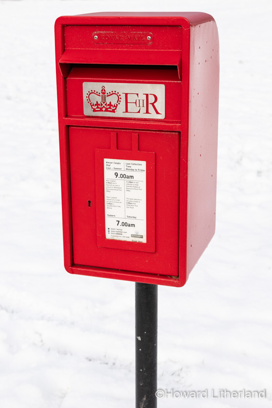 Red Royal Mail postbox in the snow