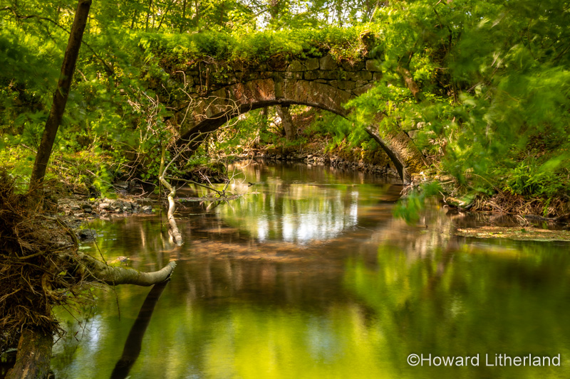 Old stone bridge over the River Alyn at Maeshafn, North Wales