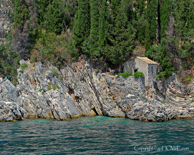 Cottage and rocks on the coast of Corfu, Greece