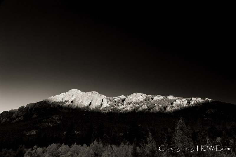 The last light of the day striking the Crags hilltop at Lily Lake, Estes Park, Colorado, U.S.A.