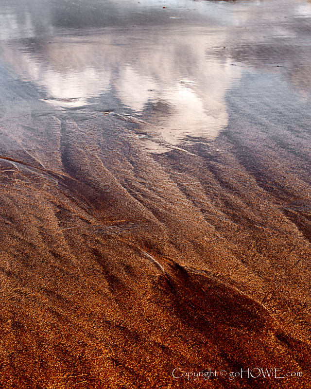 Patterns and cloud reflection in the sand on the beach at Whitesands Bay on the Pembrokeshire coast, Wales