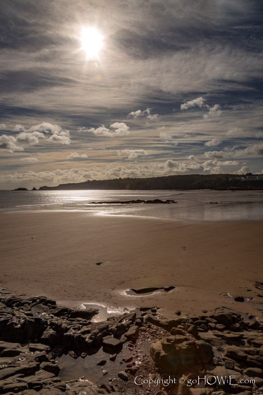 The sun shining above Saundersfoot beach, Pembrokeshire National Park, Wales