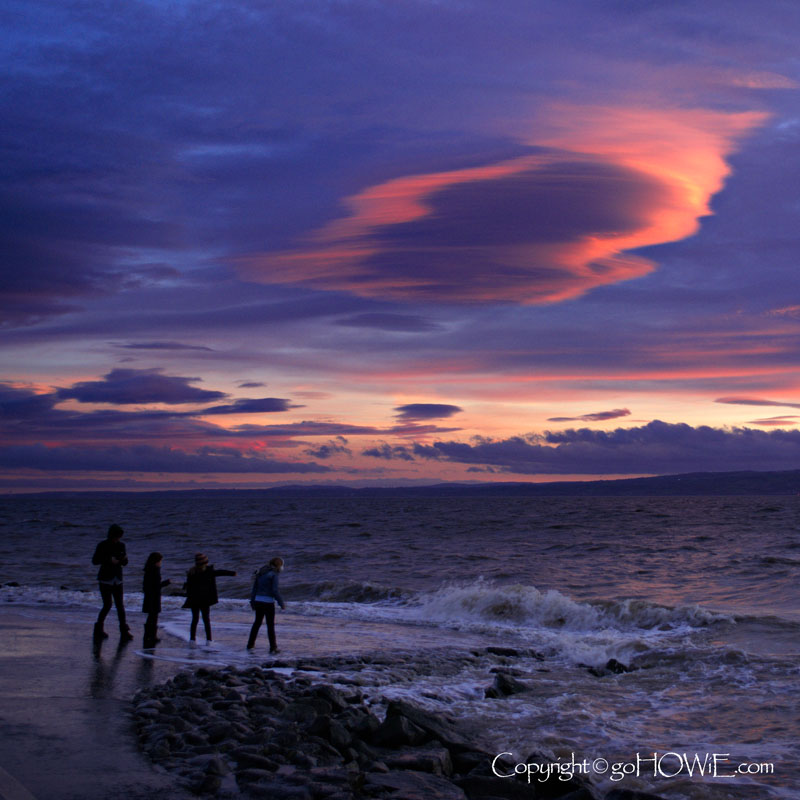 Children dodging waves at high tide at the Marine Lake, West Kirby, Wirral