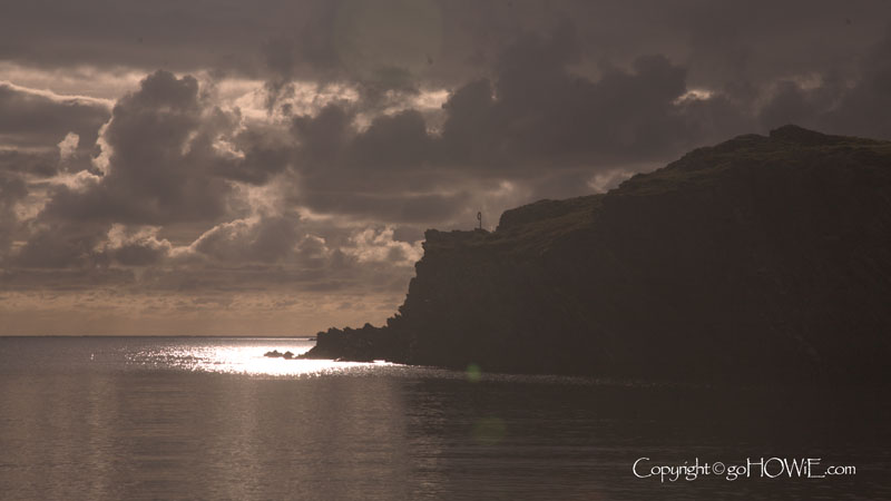 A patch of sunlit water by the cliffs at Porth Dafarch, Anglesey, North Wales
