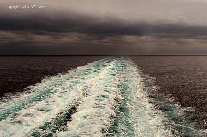 the wake from the P&O liner Arcadia under heavy cloud in the Mediterranean sea