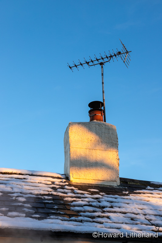 Cottage roof, chimney and aerial in winter show