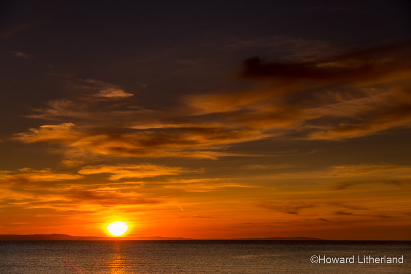 Dramatic and colourful sunset over the Irish Sea as seen from the North Wales coast at Llandudno West Shore