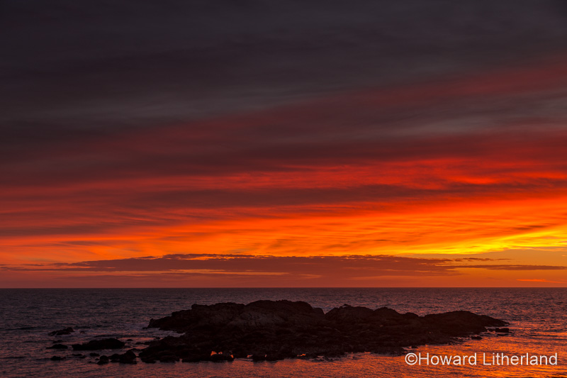 Sunset over the sea from Trearddur on the coast of Anglesey, North Wales