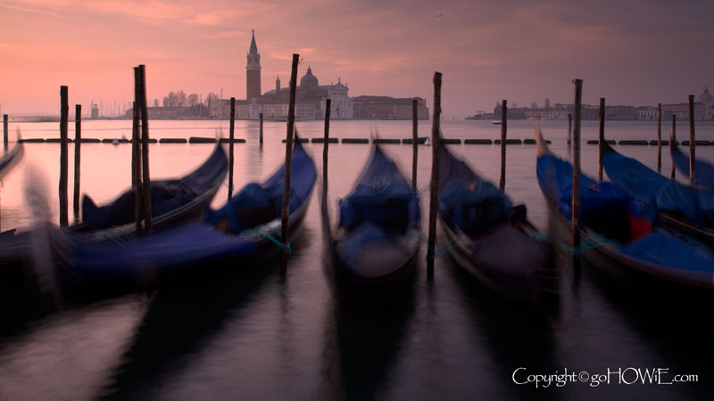 Gondolas at dawn, moored at St Mark's Square with the island of San Giorgio Maggiori in the background, Venice, Italy