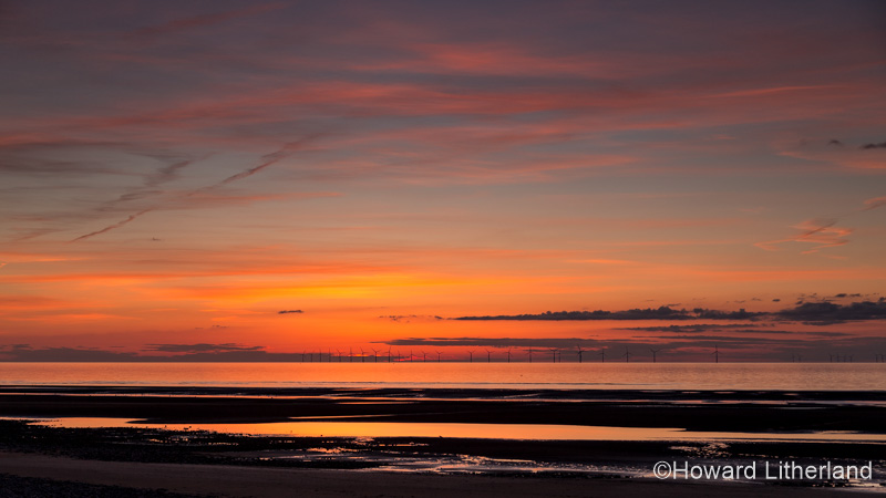 Sunset over the Gwynt y Mor windfarm from Rhyl on the North Wales coast