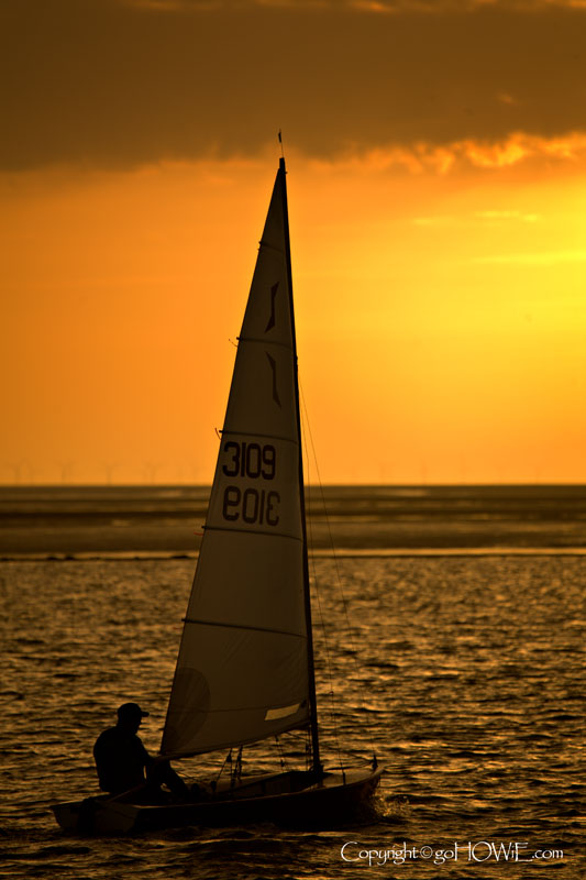 Yacht sailing at sunset on the Marine Lake, West Kirby, Wirral